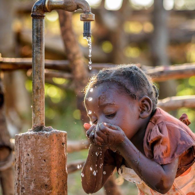 Clean water pouring into cupped hands