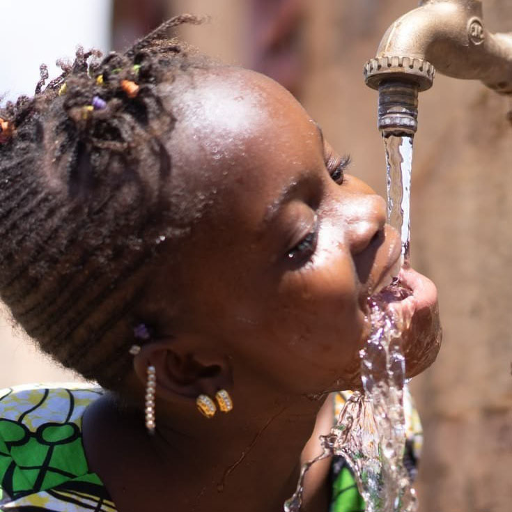 Children in Kabale, Uganda collecting clean water at a community tap